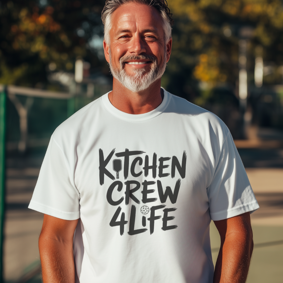Man wearing a white pickleball t-shirt with 'Kitchen Crew 4 Life' text