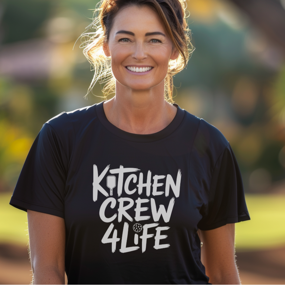 Woman wearing a black 'Kitchen Crew 4 Life' pickleball t-shirt