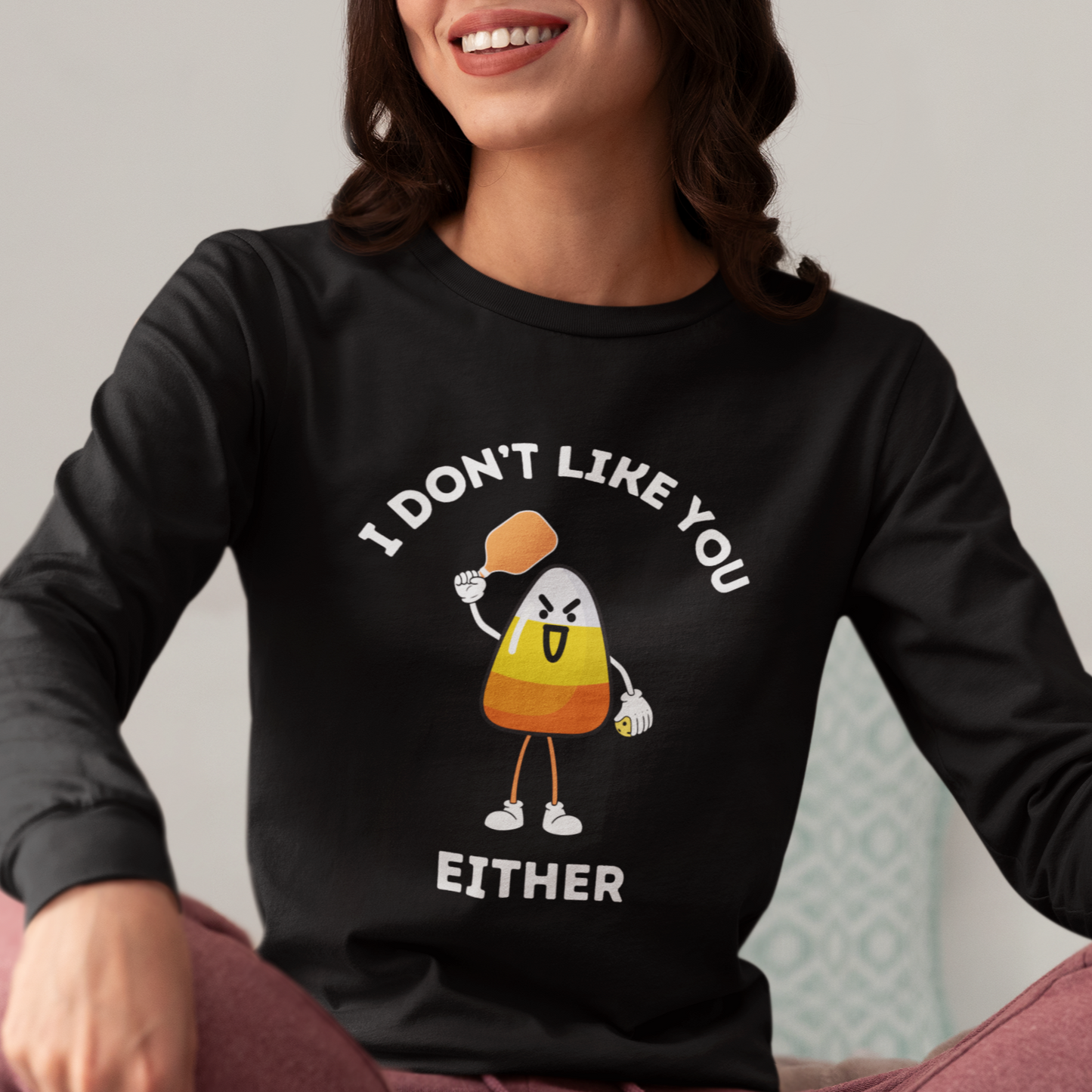 woman wearing a black long sleeve halloween pickleball tee