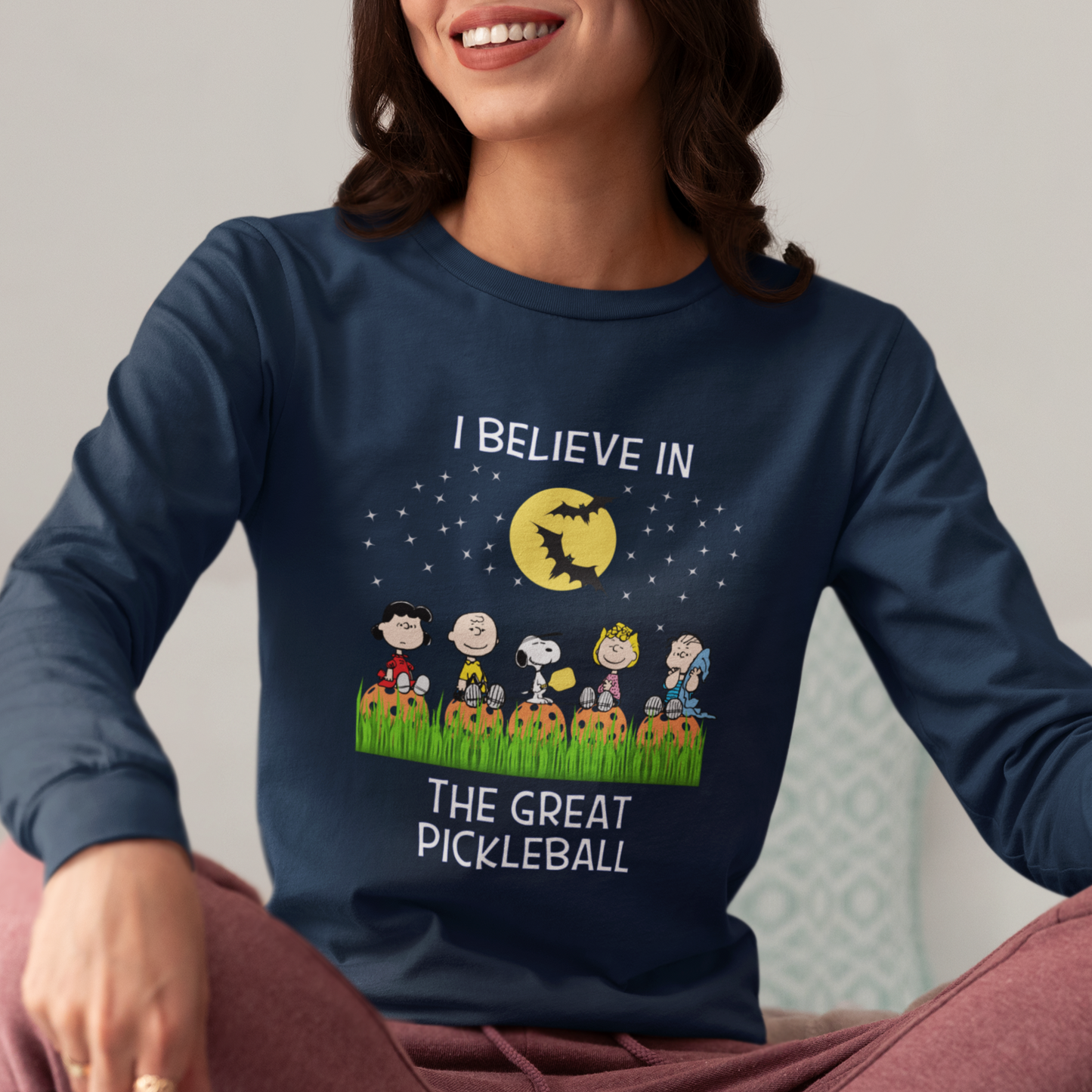 woman wearing a navy blue long sleeve halloween pickleball tee