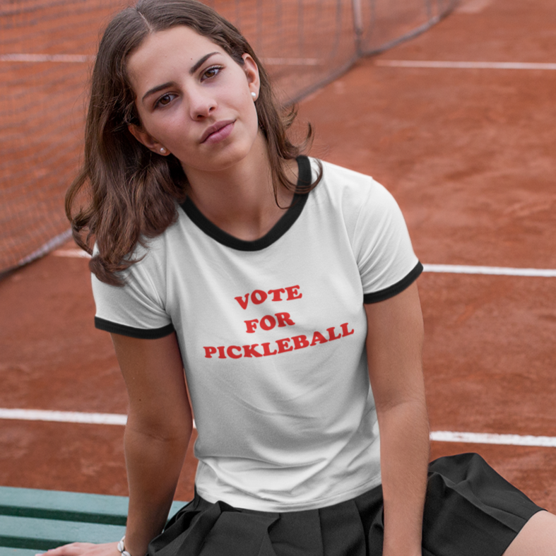 woman wearing a white pickleball t-shirt that says vote for pickleball