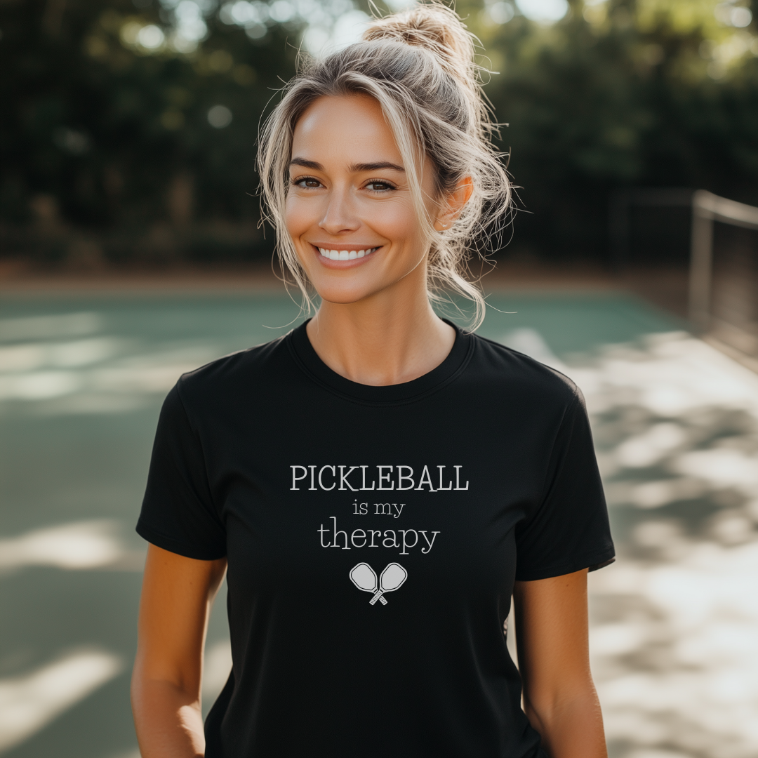 woman in a Pickleball is my therapy black pickleball tee