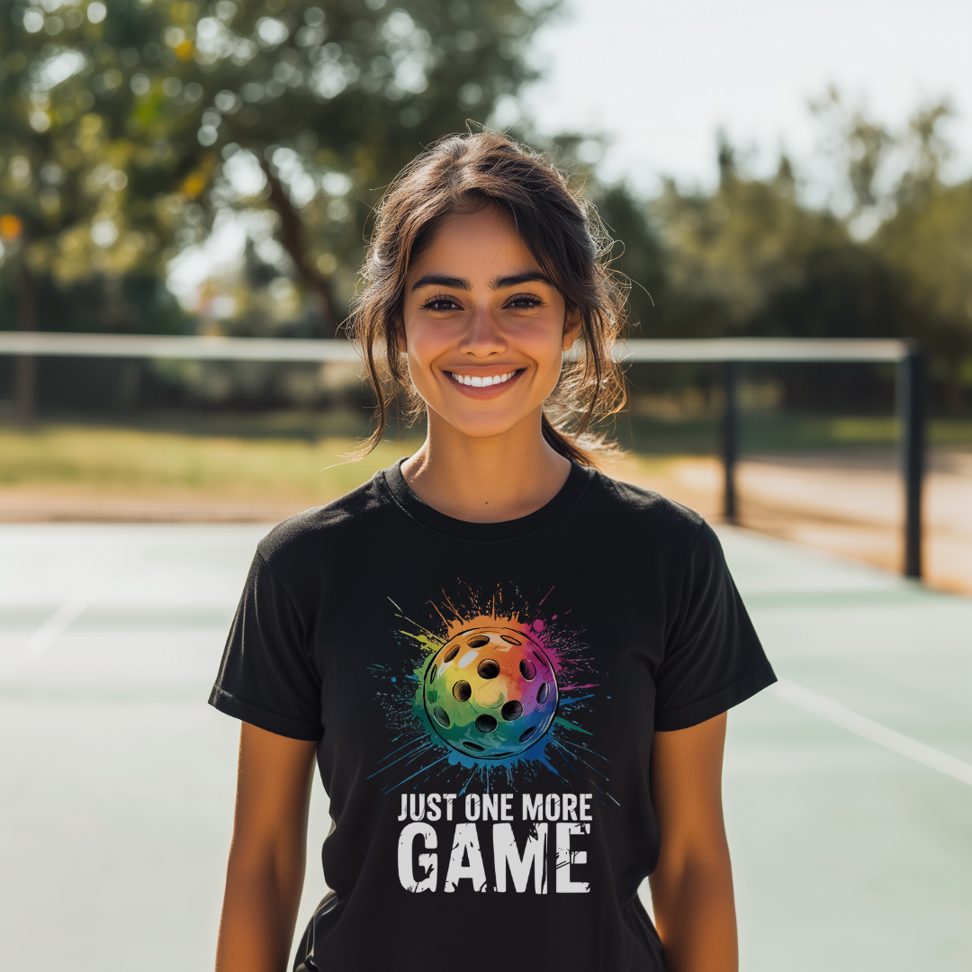 woman wearing a black one more game pickleball tee