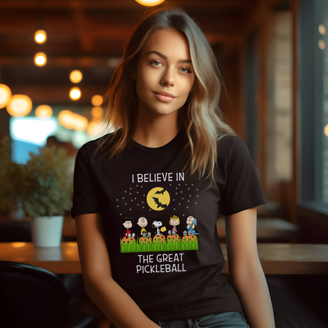 woman_wearing_a_black_pickleball_tee_that_says_i_believe_in_the_great_pickleball