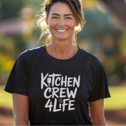 Woman wearing a black 'Kitchen Crew 4 Life' pickleball t-shirt 